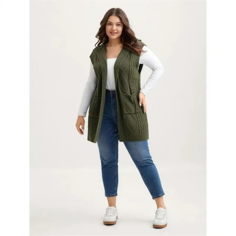 Hooded cable knit vest worn open over a long-sleeve tee and jeans