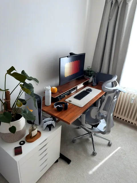 A home office desk and chair by a window