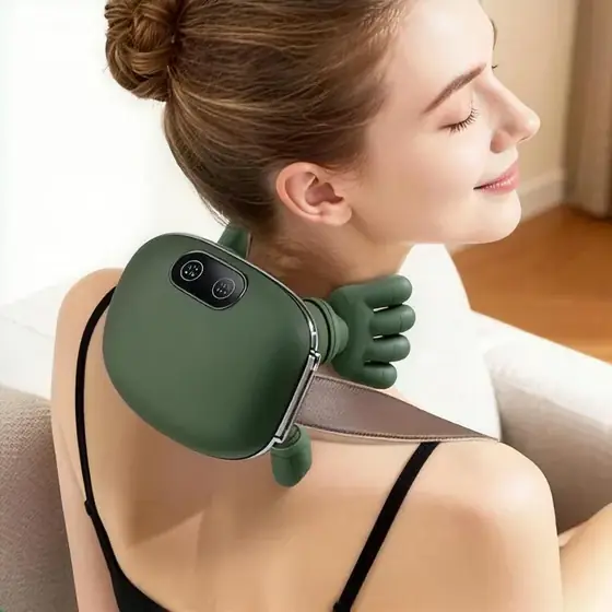 The massager resting on a woman's neck and shoulders, strap in front