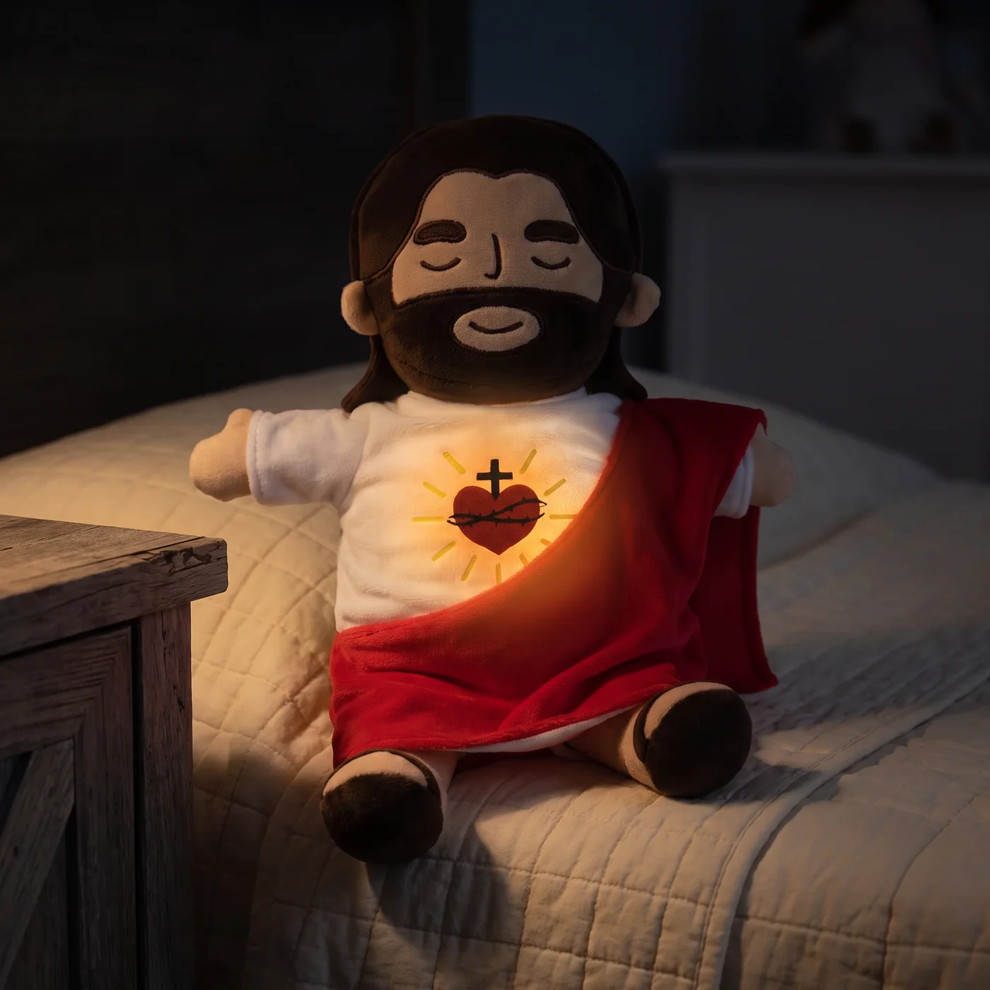 The plush's Sacred Heart glowing warm amber in a dark bedroom