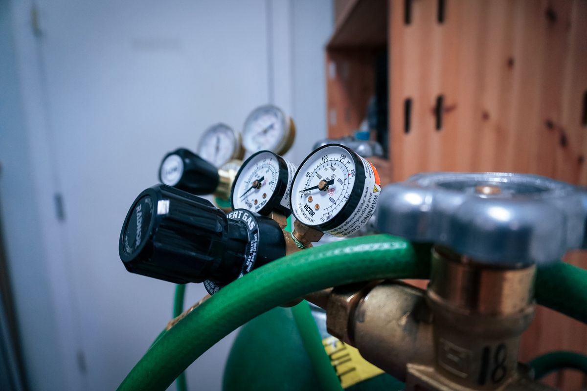 Detailed view of gas pressure gauges on equipment in an industrial setting.