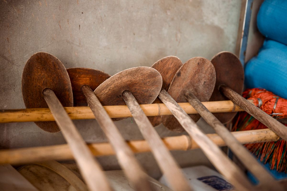 Organized rustic wooden kitchen tools on a traditional rack, showcasing craftsmanship.