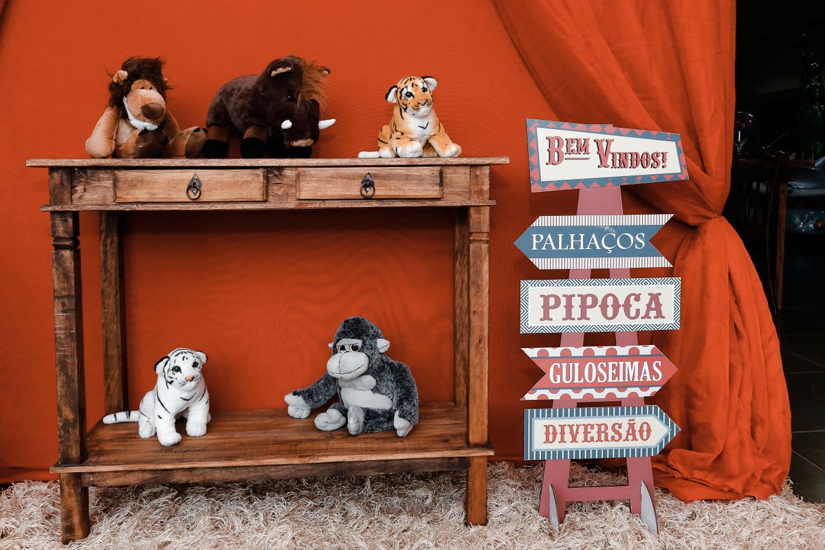A vibrant kids' room featuring a wooden shelf with plush animals and colorful signage.