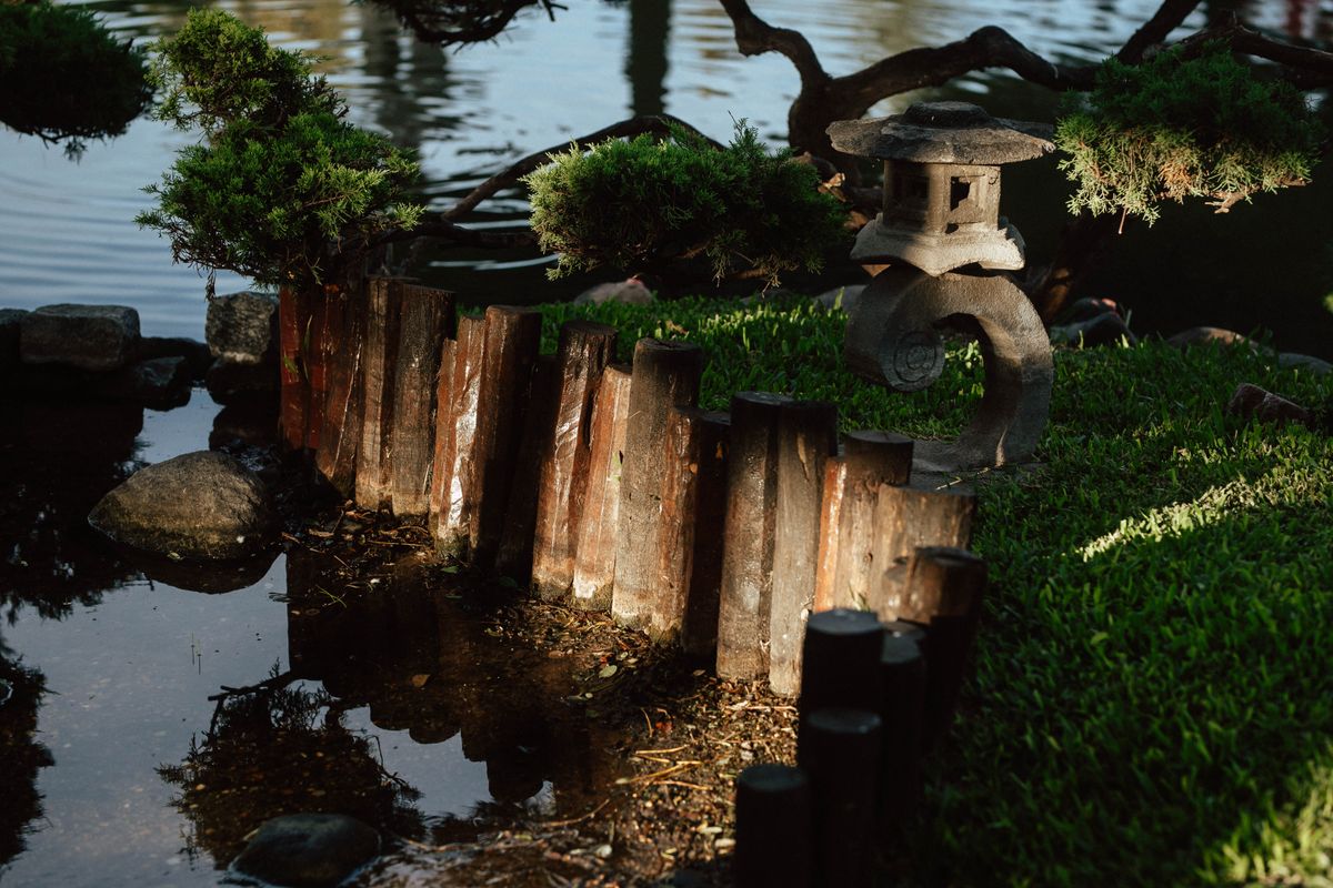Serene Japanese Zen garden with lantern and greenery in Buenos Aires.