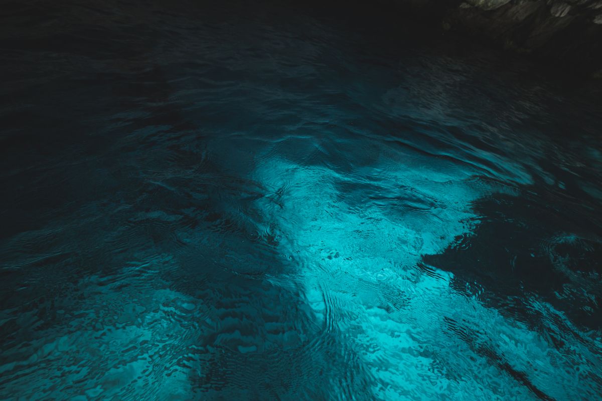 A mesmerizing view of clear blue water with light reflections creating a calming effect.