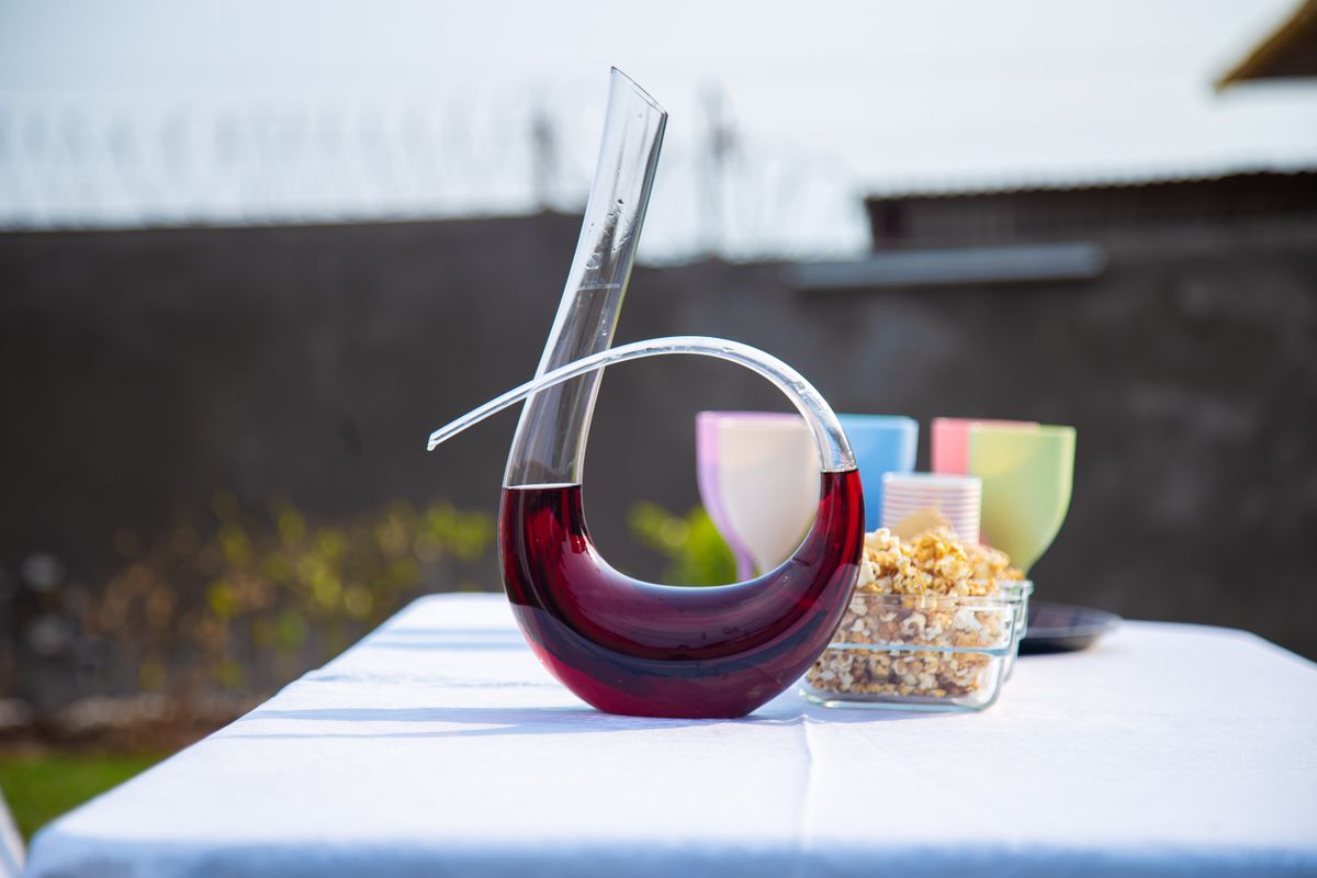 Sophisticated outdoor setup featuring a modern wine decanter with popcorn and glasses.