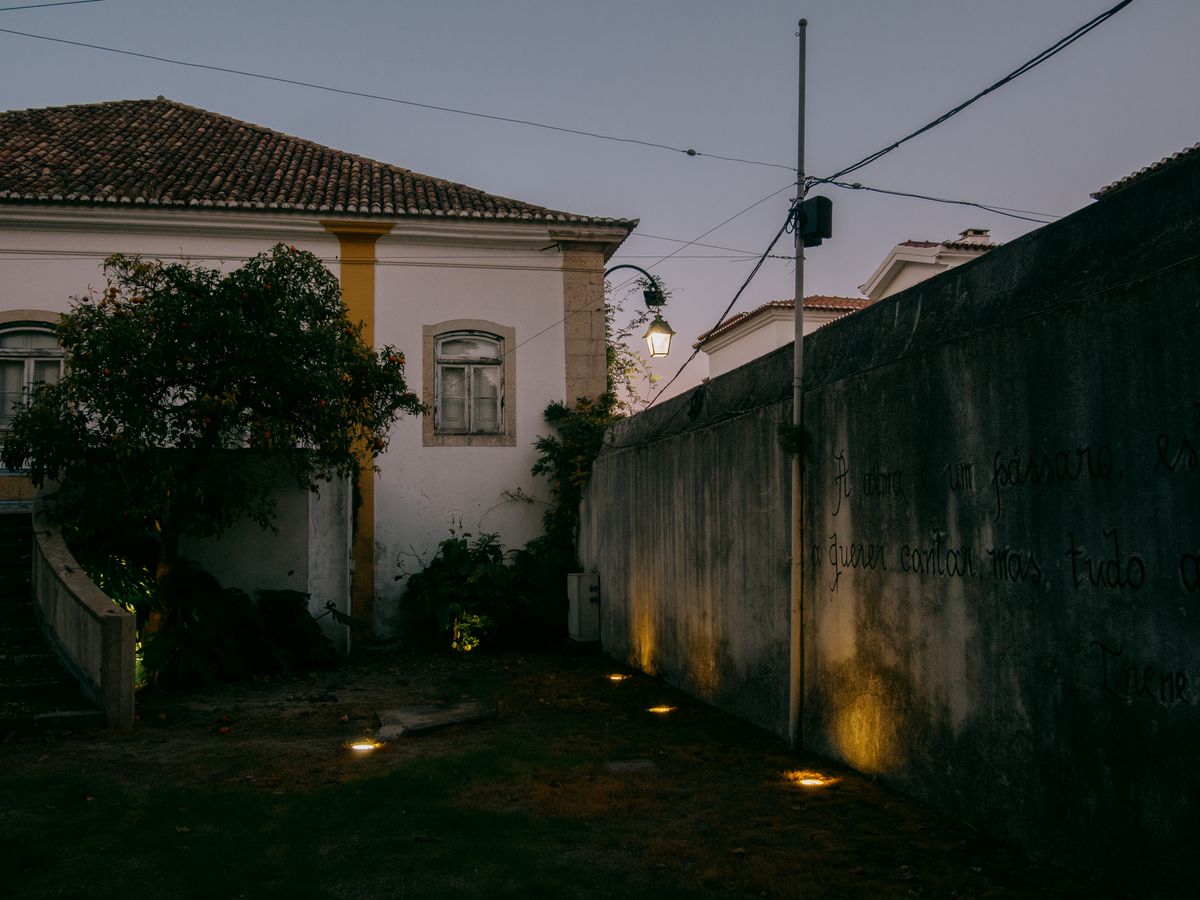 Elegant historic house illuminated in evening light, showcasing traditional architecture.