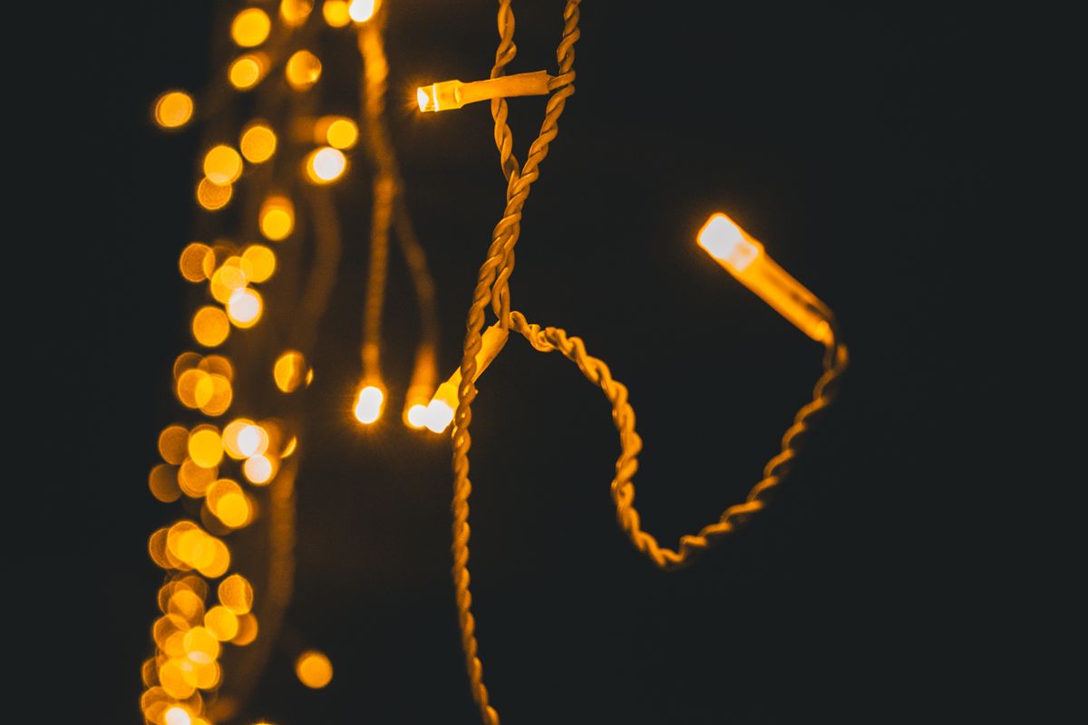 Warm and vibrant close-up of illuminated string lights against a dark background.