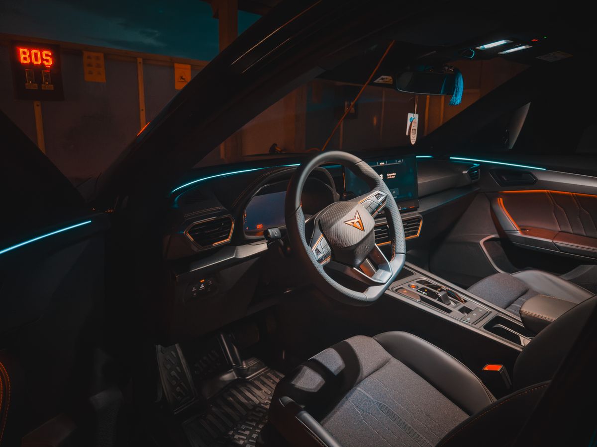Explore this sleek car interior featuring ambient lighting and digital dashboard.
