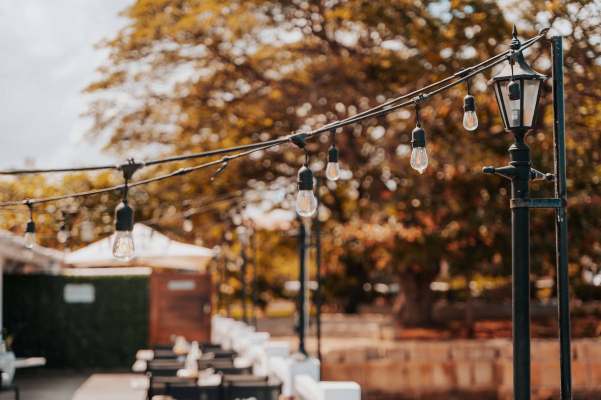 Warm string lights and lampposts create a cozy outdoor atmosphere in Zanzibar.