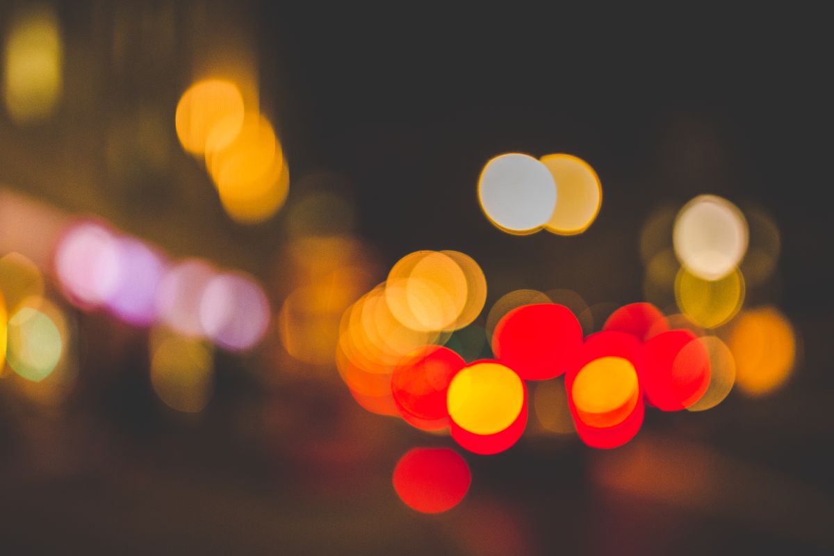 Abstract bokeh with vibrant, colorful lights creating a dreamy urban night atmosphere.