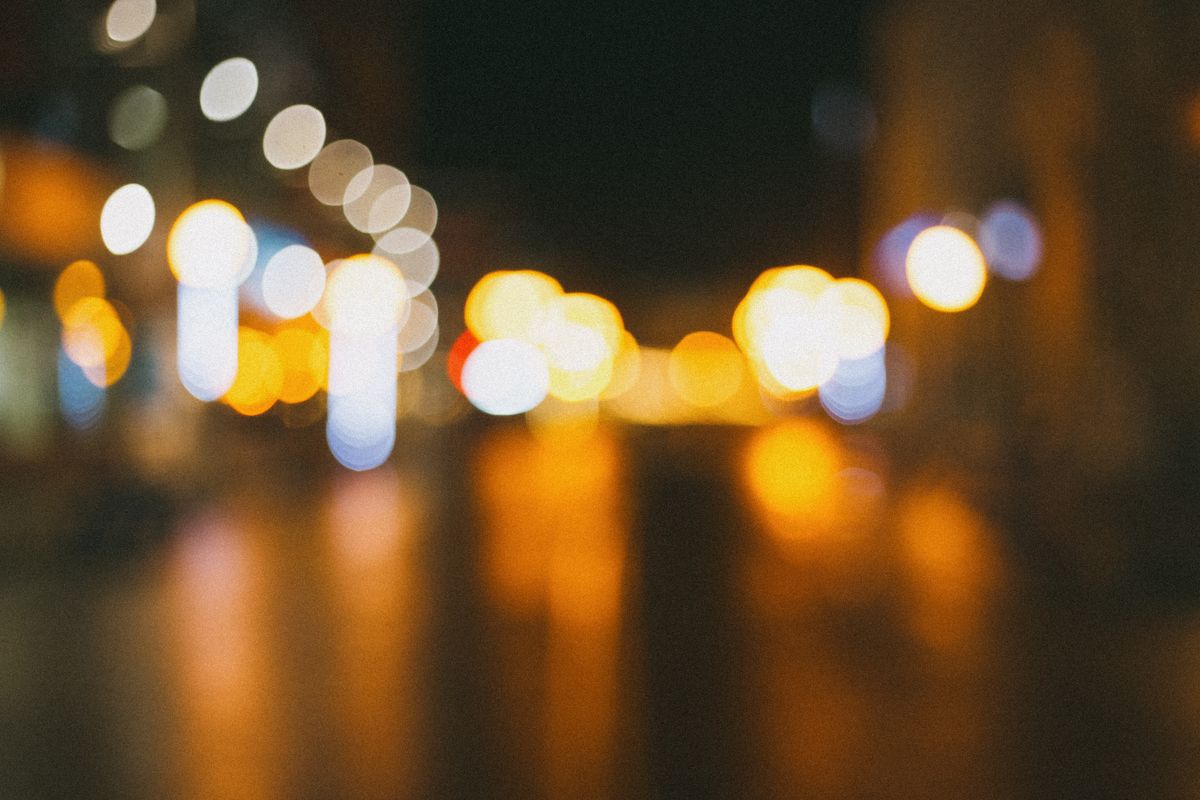 Blurred city street lights creating an abstract bokeh effect at night, offering a vibrant urban atmosphere.