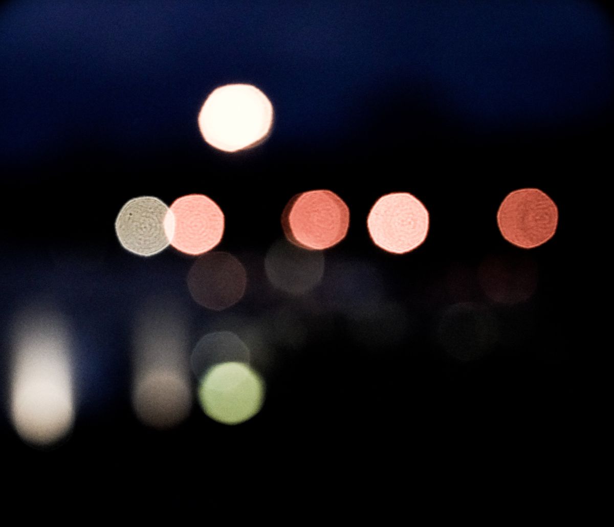Abstract photo of colorful bokeh lights against a dark night sky.