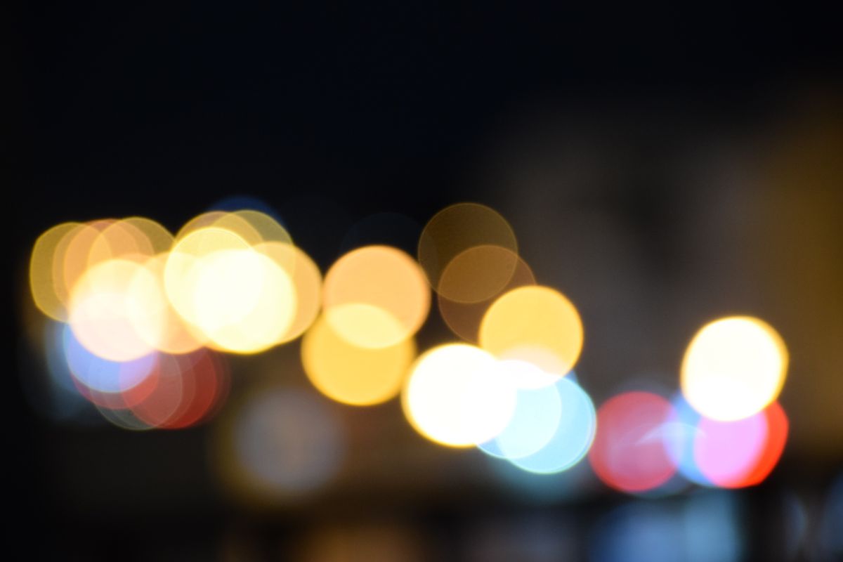 Vibrant and abstract bokeh lights illuminate the night sky, creating a stunning visual display.