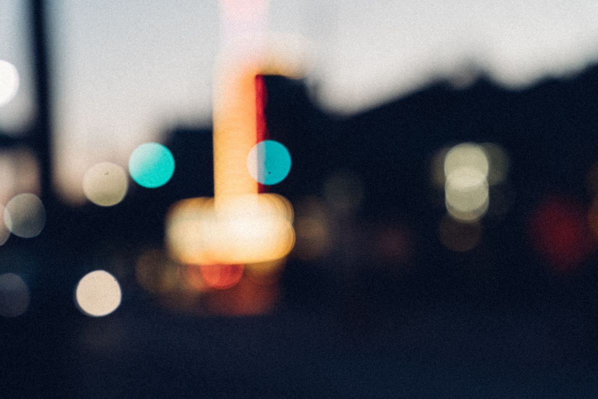 Blurred city night lights with bokeh effect creating a dreamy ambiance.