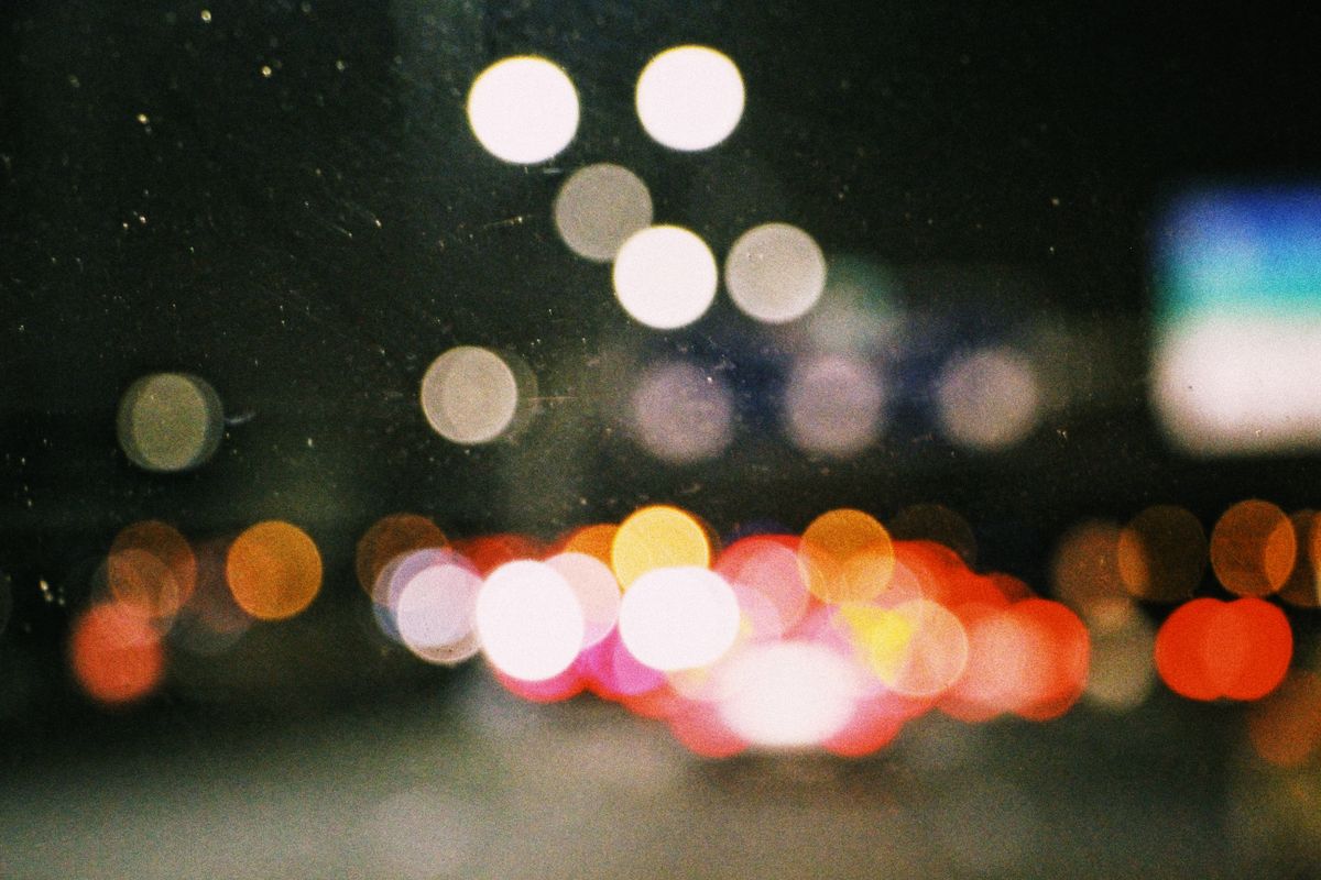 A colorful bokeh image of city lights at night, creating an abstract and vibrant composition.