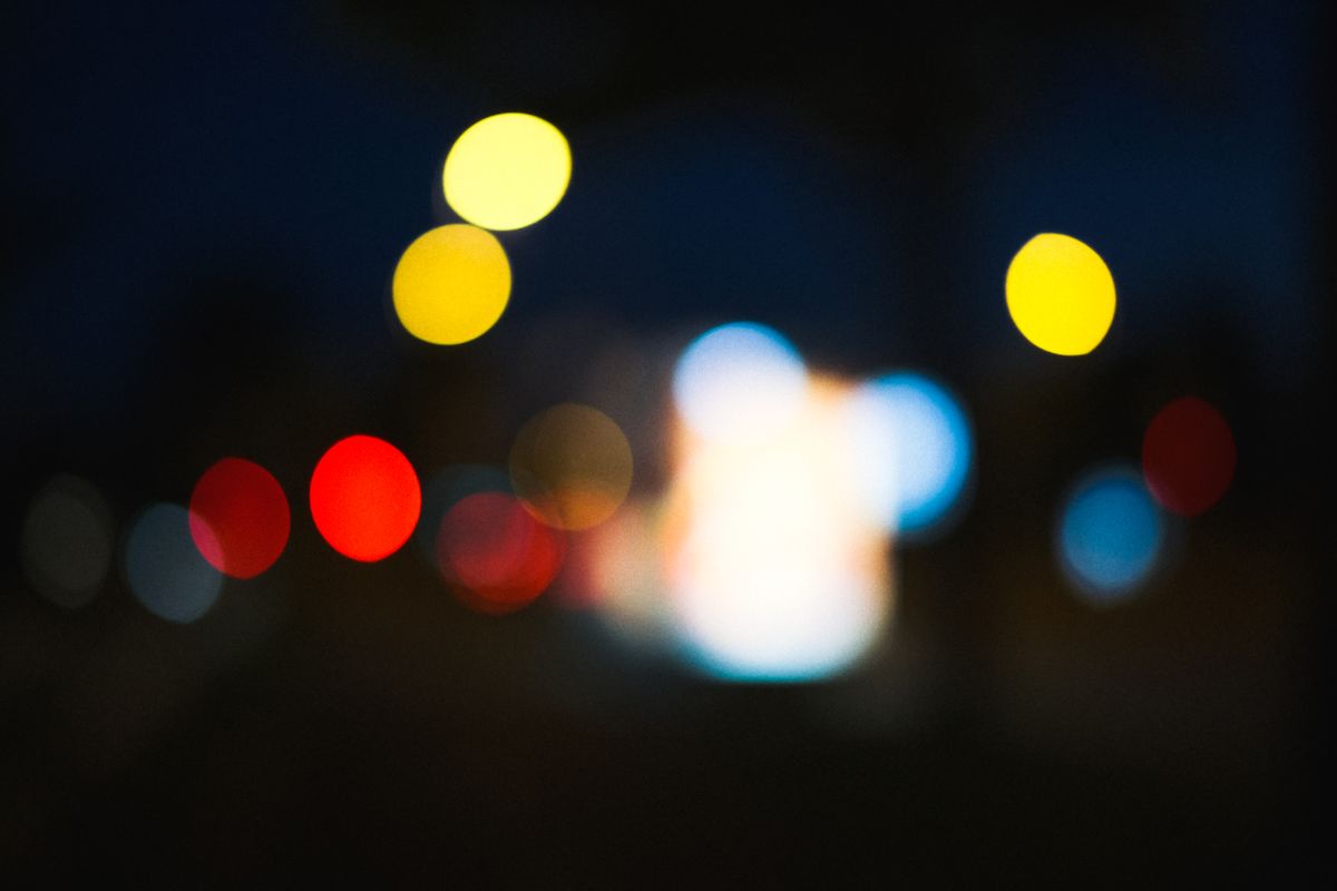 Vivid bokeh of colorful lights against a dark night sky, creating a dreamy ambiance.