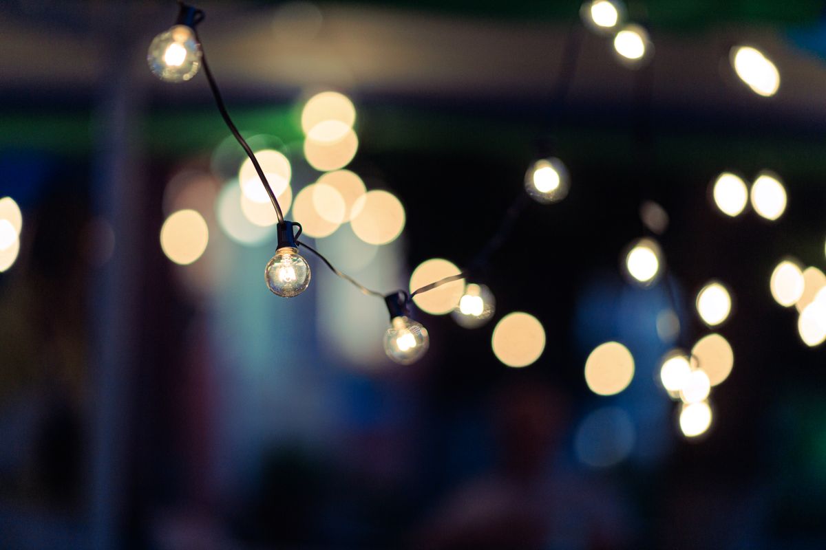 Close-up of string lights creating a dreamy bokeh effect at night, perfect for festive occasions.