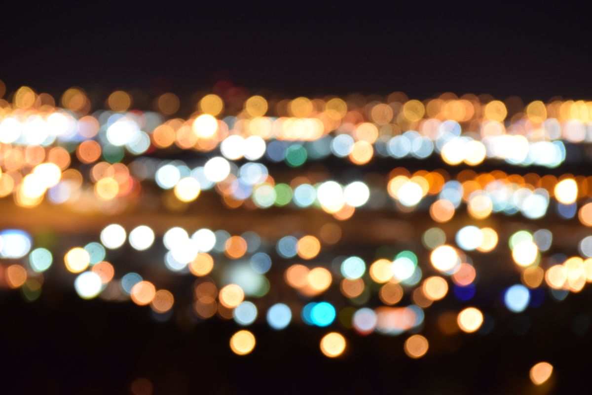 A mesmerizing view of blurred city lights creating a colorful bokeh effect at night.