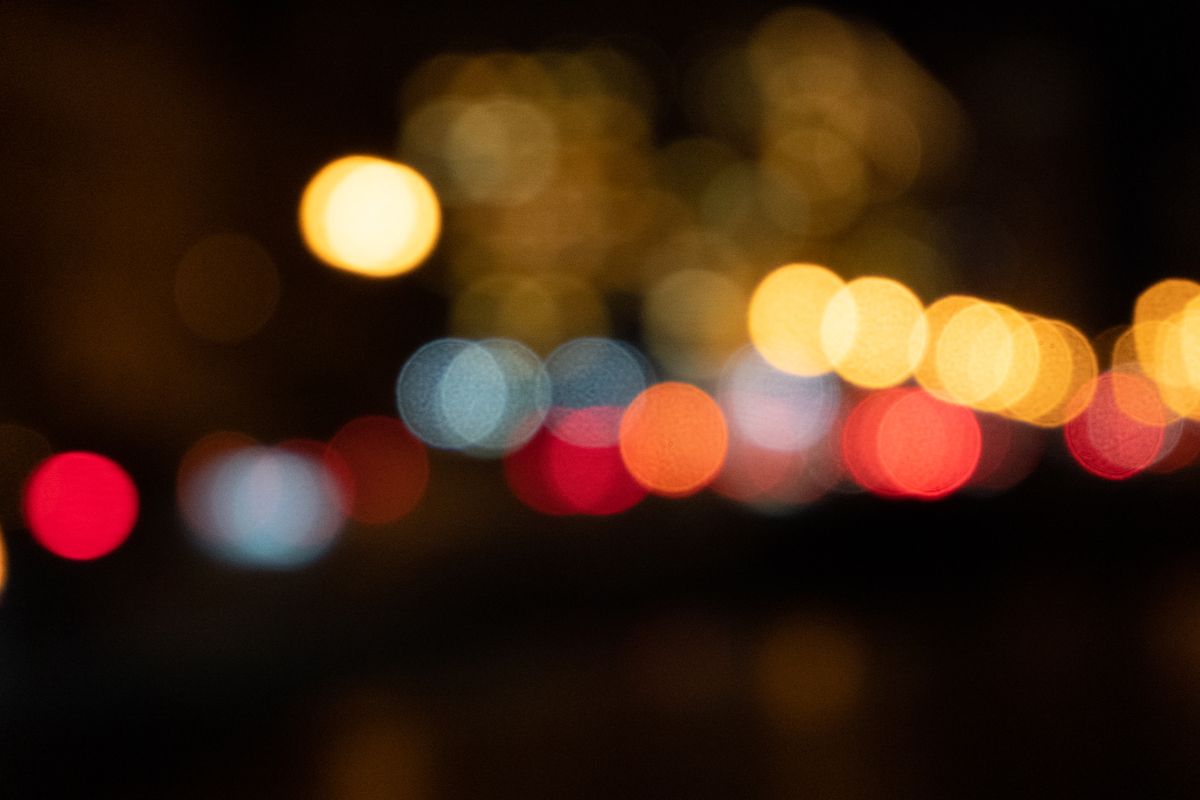 Blurred bokeh lights creating an abstract pattern against the night backdrop.