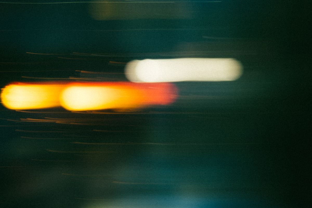 A dynamic abstract image capturing the blurred motion of colorful neon lights at night.