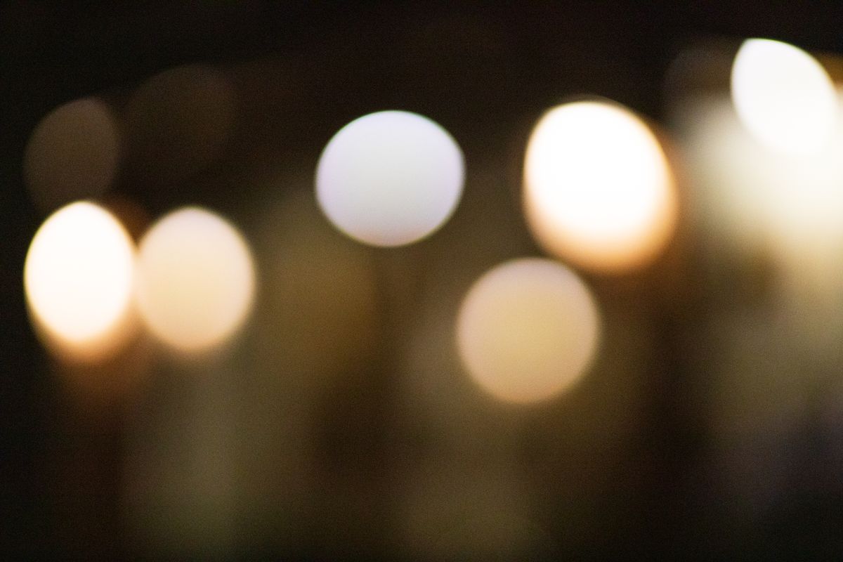 Defocused abstract bokeh backdrop of bright oval and round shaped lights spreading at night