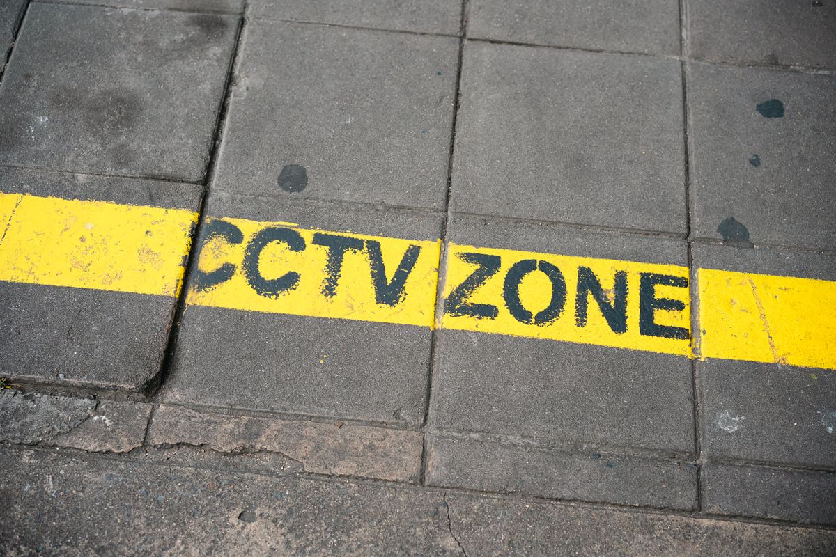 CCTV zone warning sign on a city sidewalk, emphasizing security and surveillance.