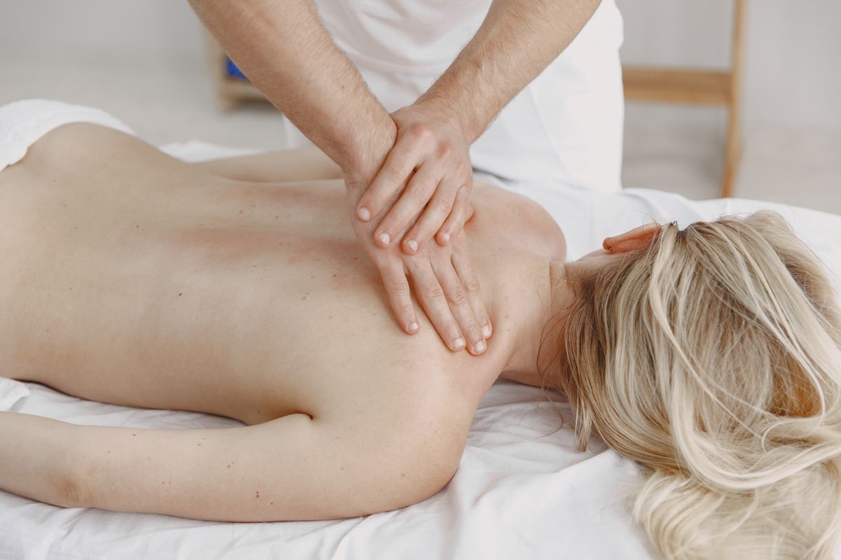 Close-up of a relaxing back massage in a serene massage room, highlighting self-care and wellness.