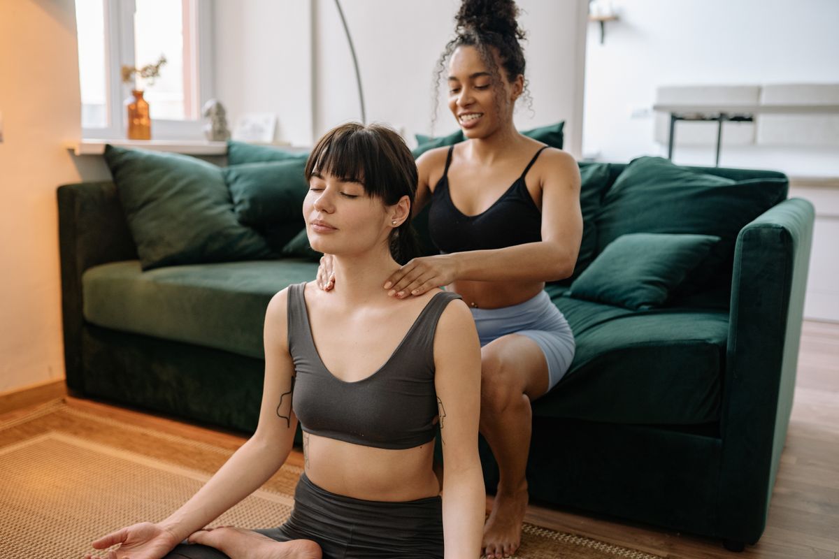 Two women enjoying a relaxing at-home massage, promoting wellness and friendship.