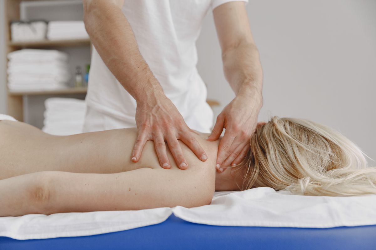 A tranquil massage session focusing on relaxation and self-care, featuring a woman receiving a back massage.