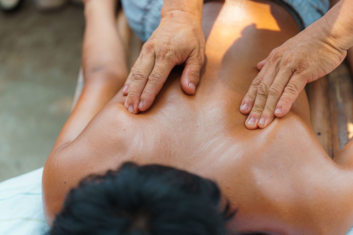 Close-up of a relaxing massage therapy session on a person's back, promoting wellness and relaxation.