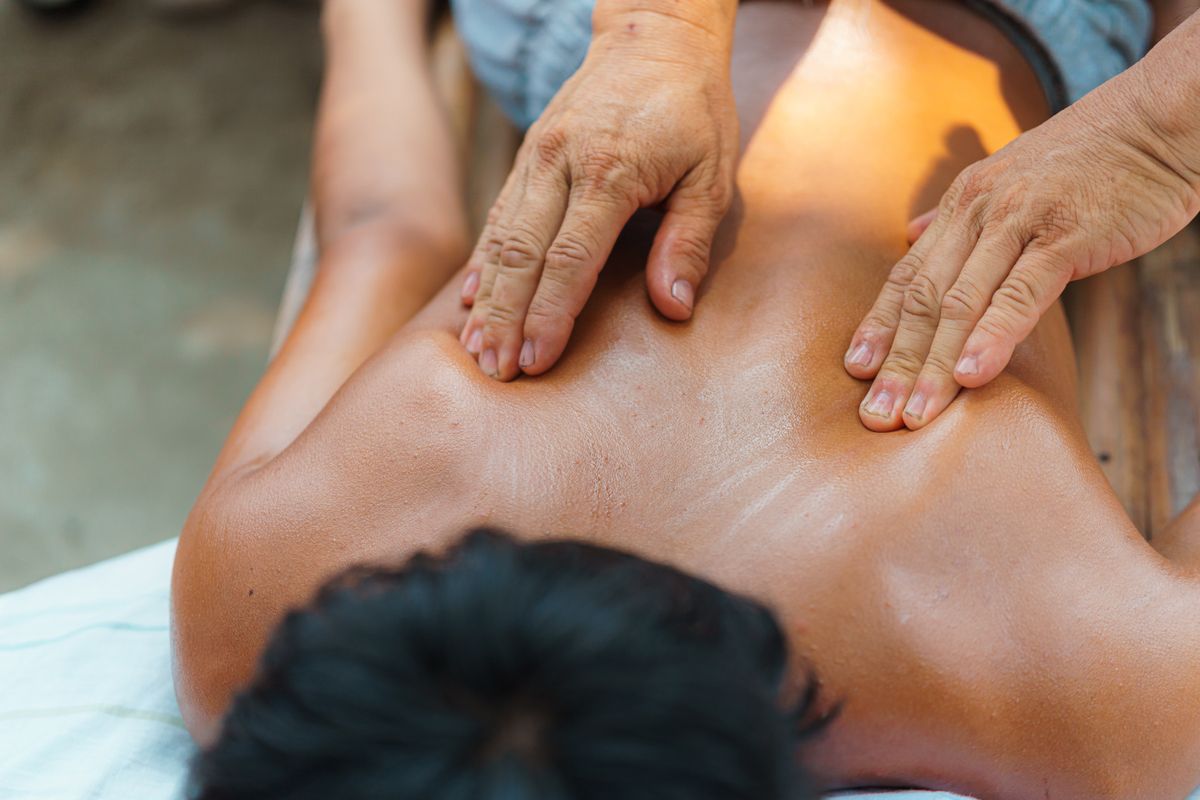 A soothing outdoor massage session focusing on relaxation and wellness, enhancing physical and mental health.