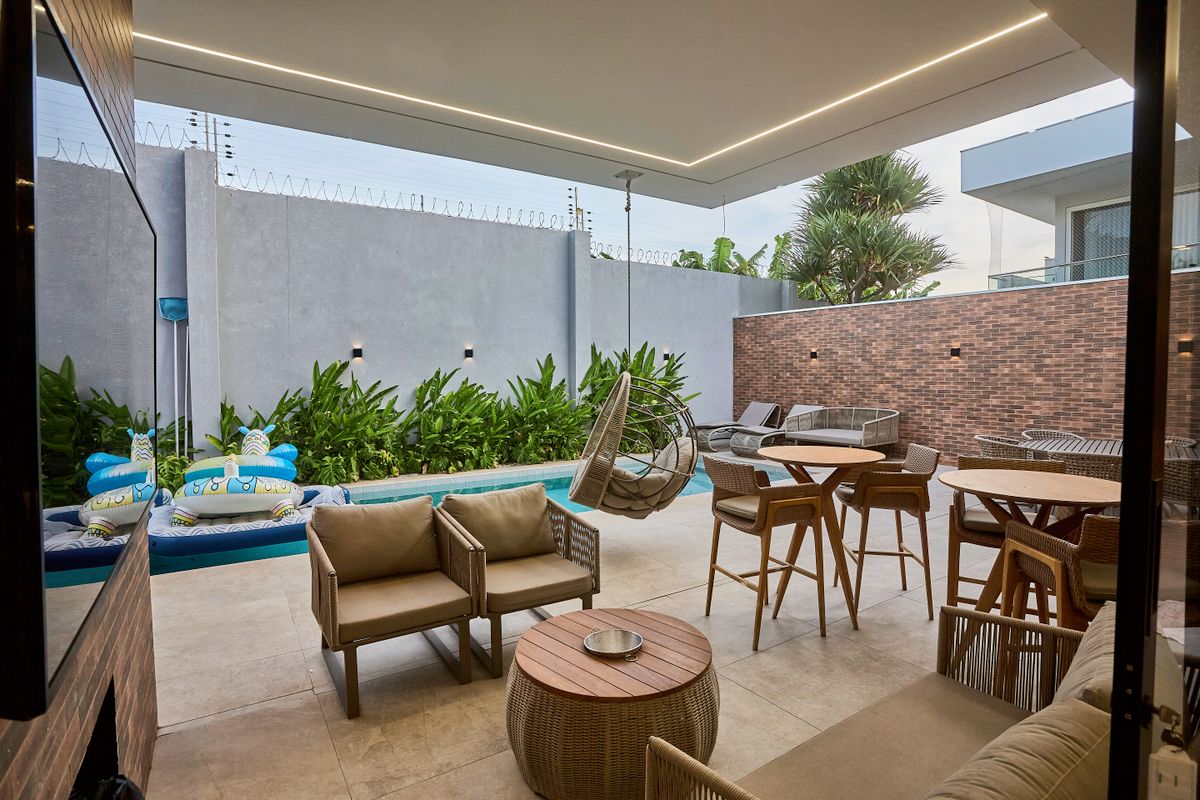 Luxurious outdoor patio setup with stylish seating and pool view.