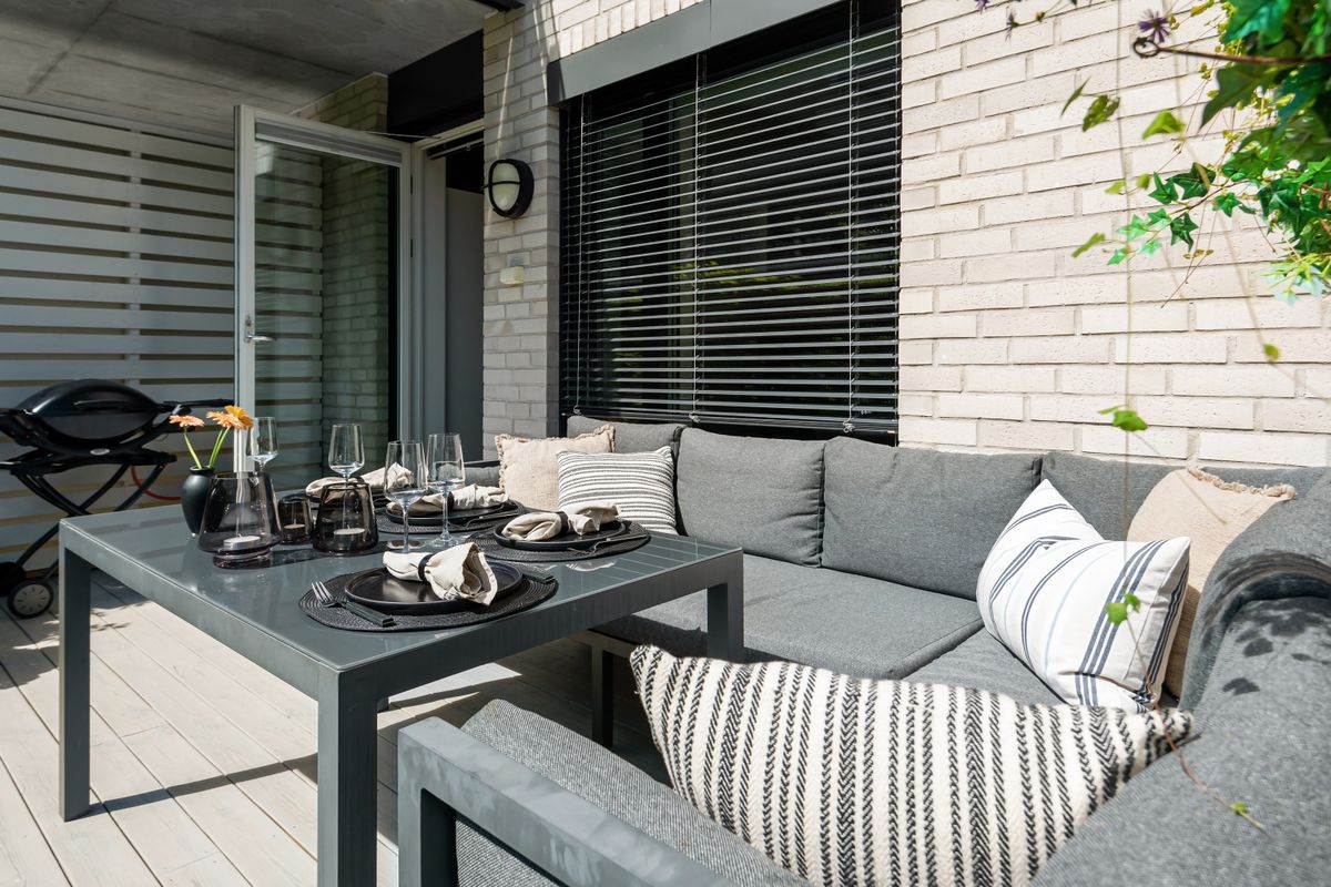 Modern outdoor patio with contemporary furniture, perfect for summer relaxation.