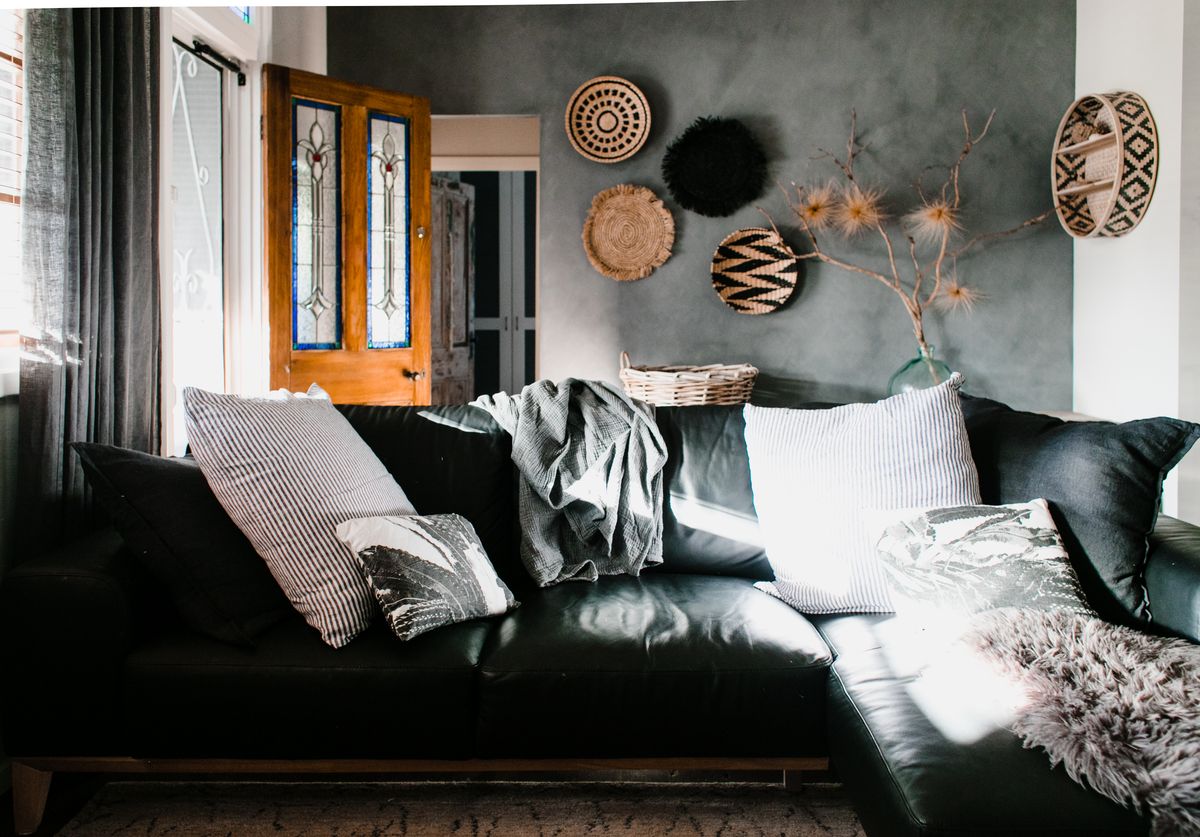 Cozy living room with sunlit leather sofa and modern interior decor elements.