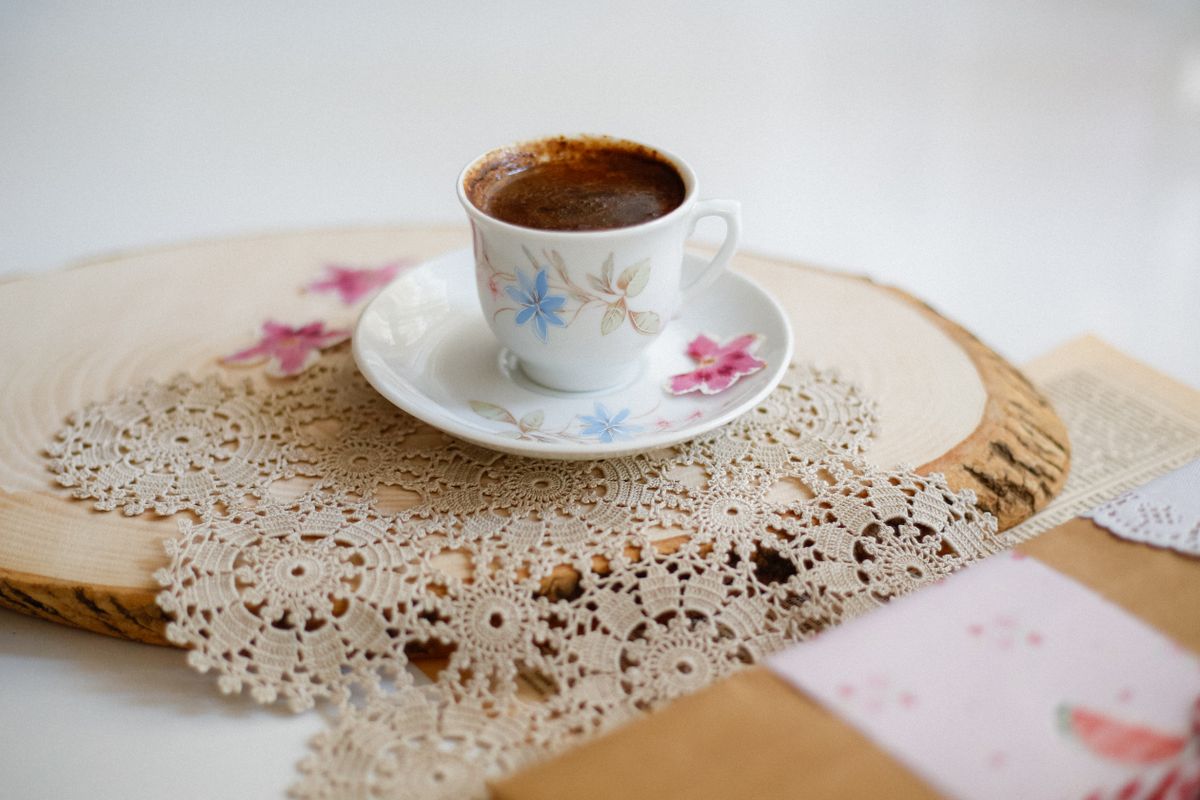 Beautiful coffee cup on an intricate lace doily, offering a cozy and elegant vibe.