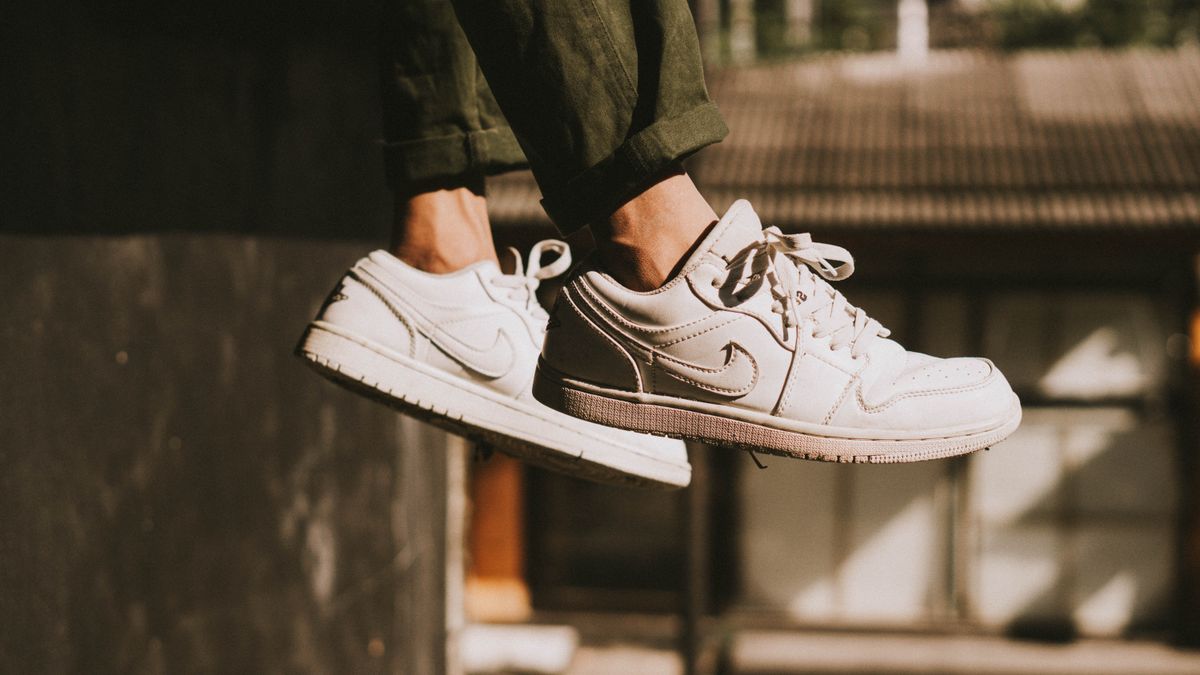 Dynamic shot of a person wearing trendy sneakers jumping outdoors in Bali.