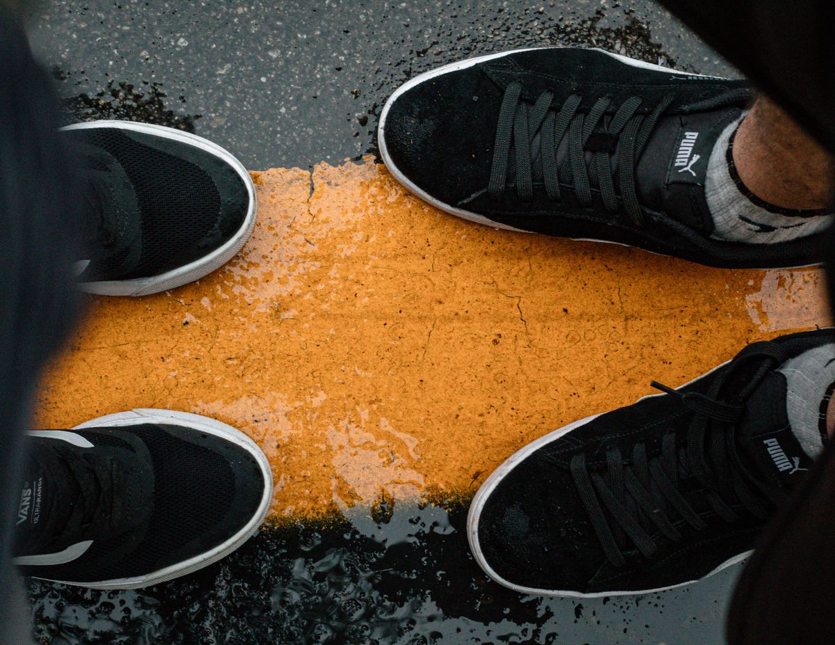 Close-up of sneakers on a wet street in São Paulo. Street style and sneaker culture.