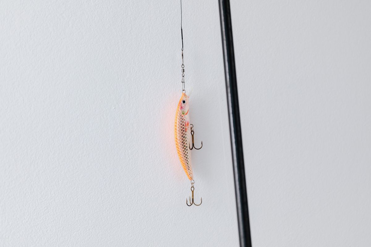 Detailed close-up of a fishing lure attached to a fishing rod, perfect for angling or fishing enthusiasts.