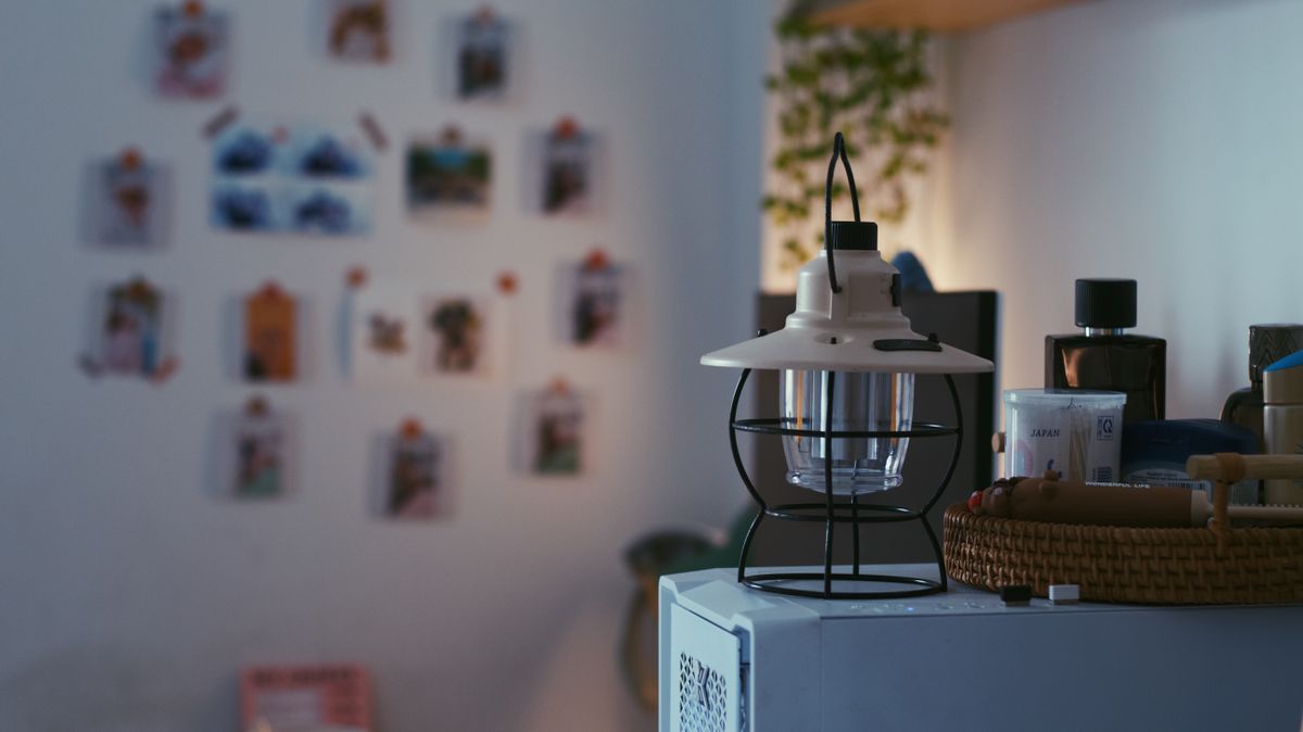 A contemporary interior featuring stylish home decor and a modern lamp on a cabinet.