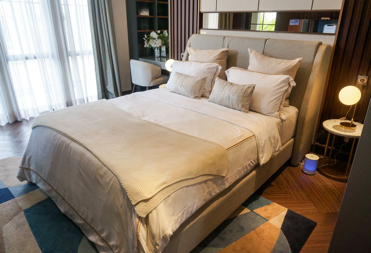 Cozy and elegant modern bedroom interior with neutral tones and stylish decor.