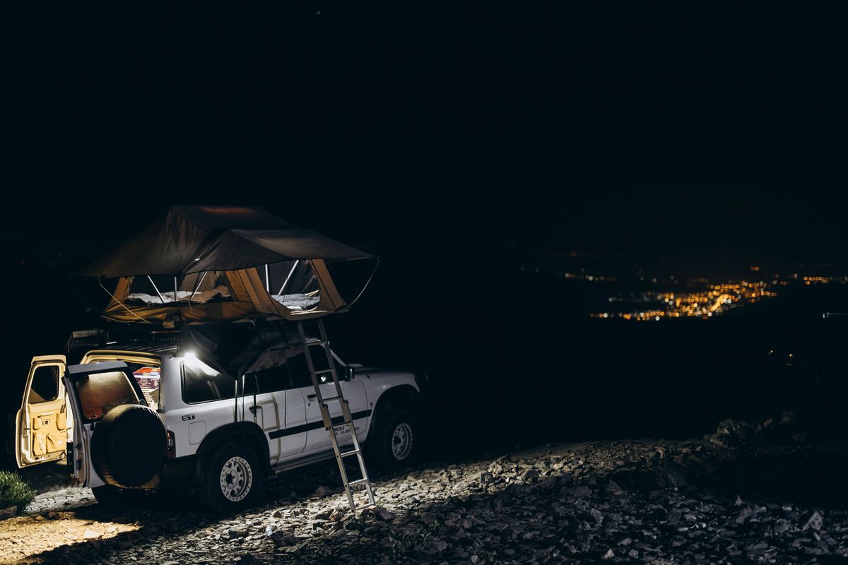 Explore off-road camping under a starry sky in Oman, capturing adventure and nature's serenity.