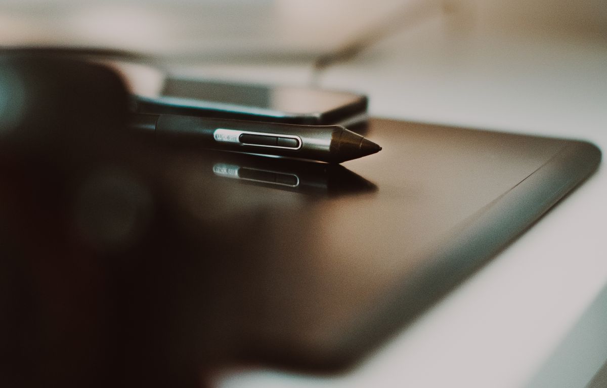 Close-up of a stylus and tablet on a desk, perfect for creative and tech themes.