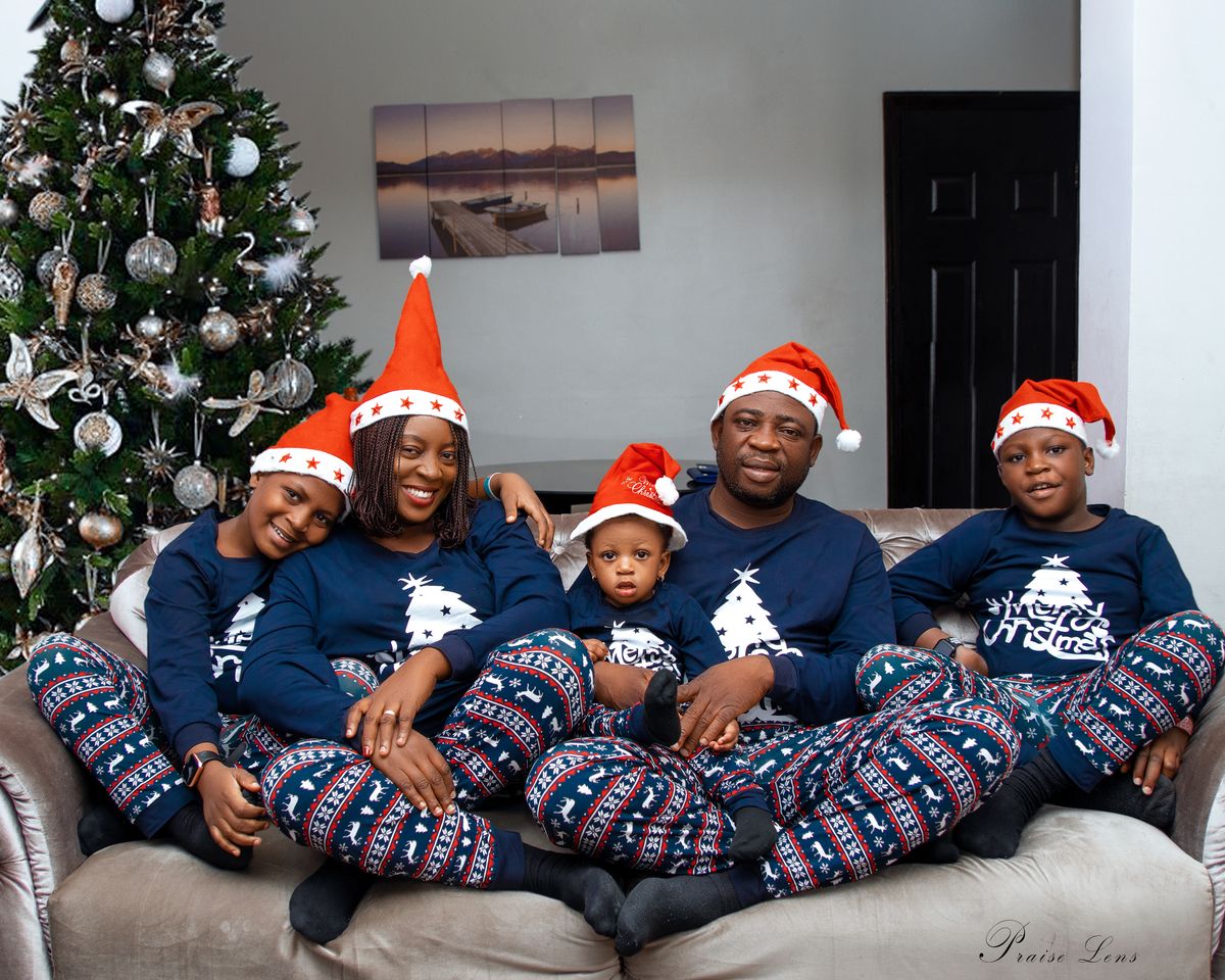 A joyful family in festive pajamas celebrating Christmas with smiles and love.
