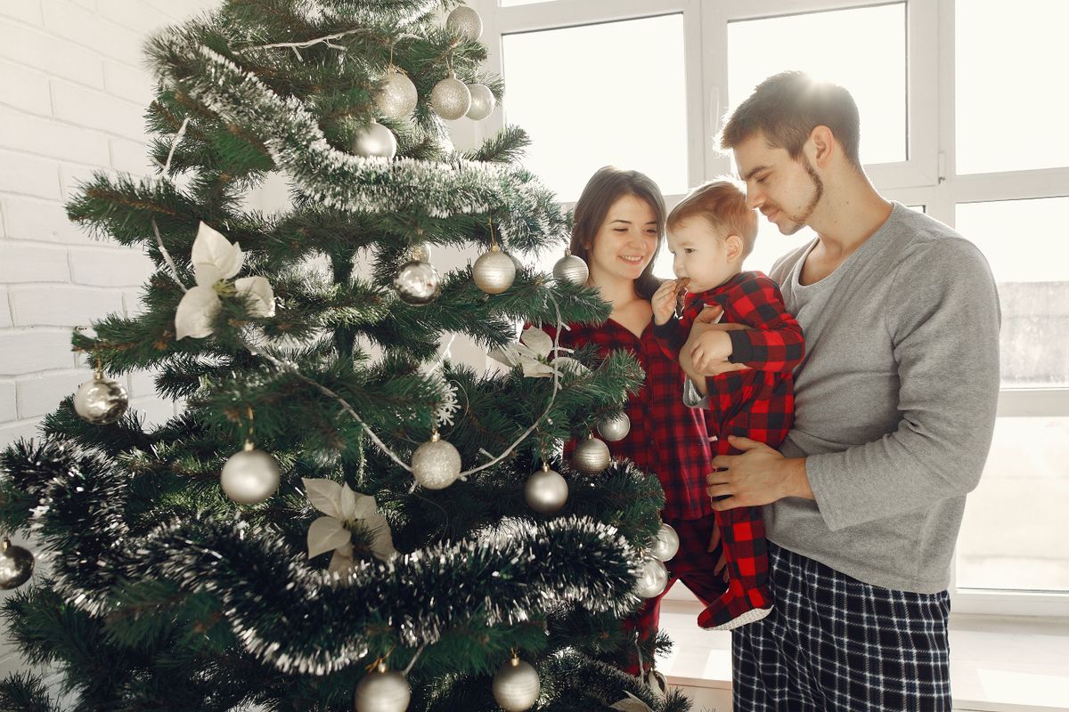 A family enjoys decorating their Christmas tree during the festive holiday season.