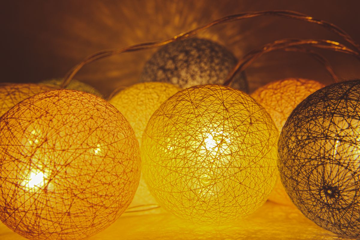 Warm glowing string lights with decorative texture, casting ambient illumination.