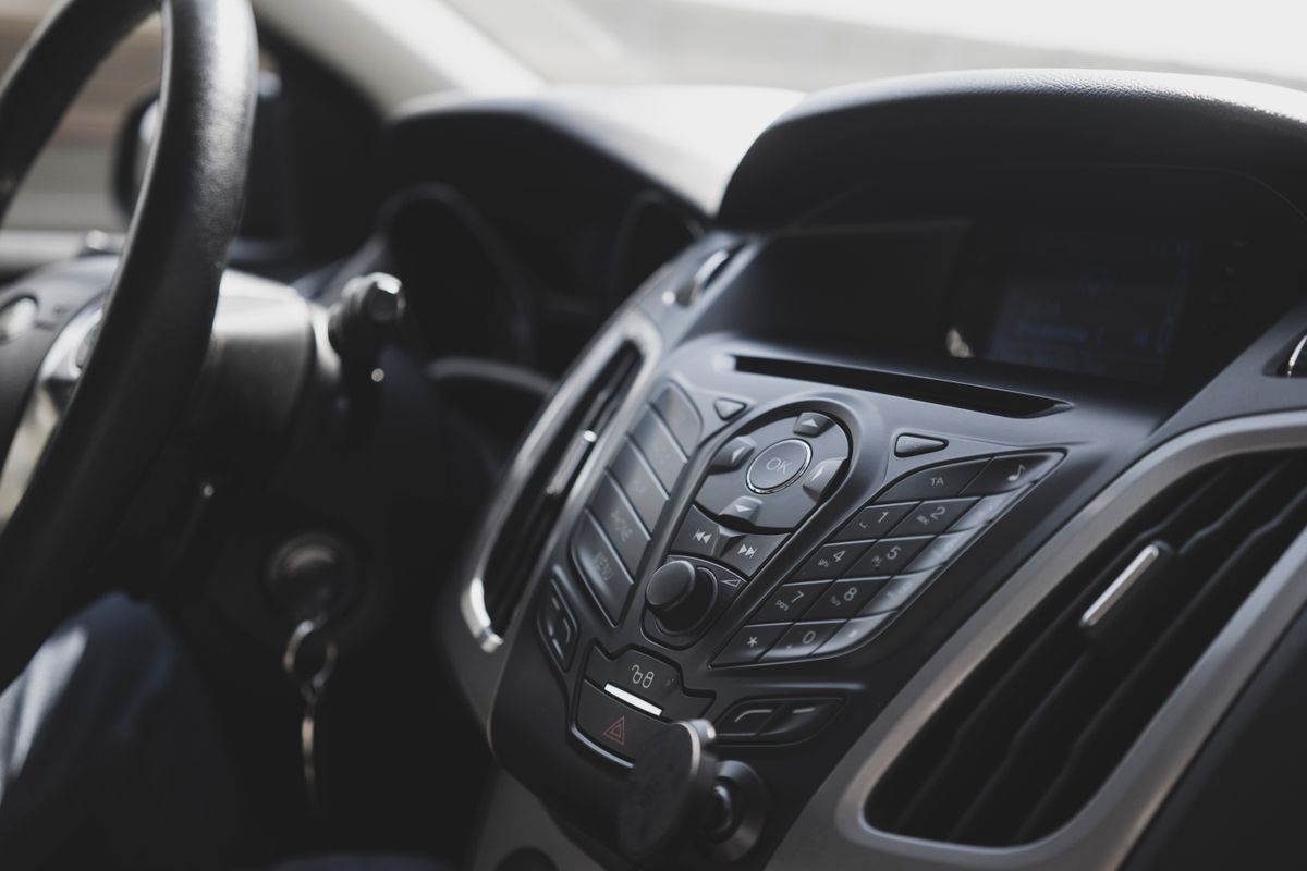 Close-up view of a modern car interior focusing on the dashboard and steering wheel.
