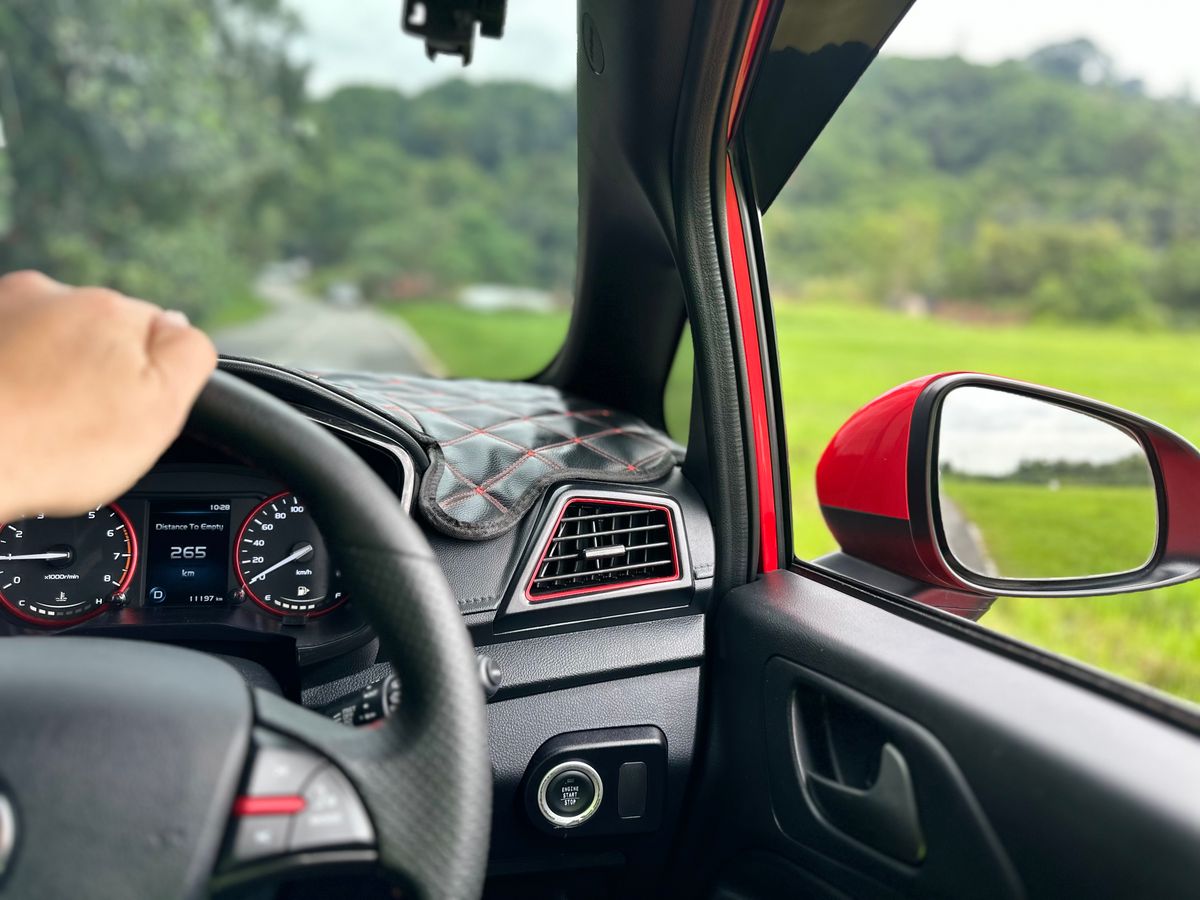 View from car interior driving through lush Banting countryside in Selangor, Malaysia.