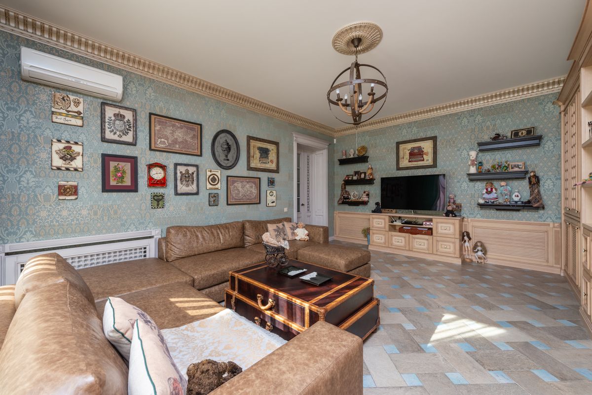 Spacious living room with ornate decor and modern furniture in a cozy home setting.