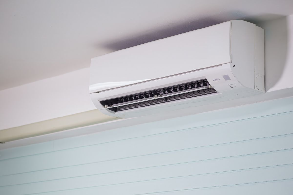 Close-up of a wall-mounted air conditioner indoors, showcasing sleek design for modern cooling solutions.